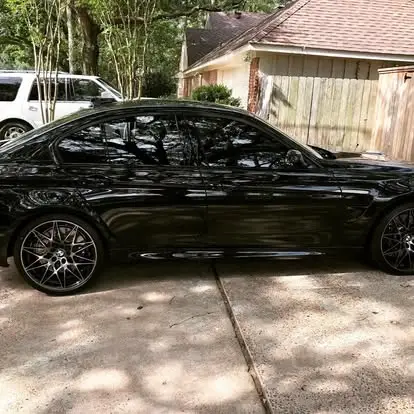 Mirror-gloss ceramic coating finish on a black BMW