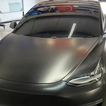 Custom matte black vinyl wrap on a Tesla